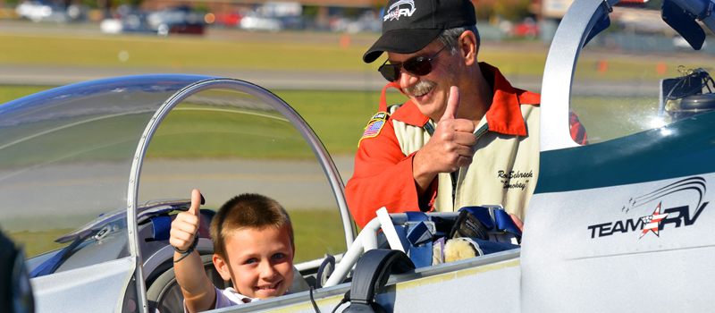 Boy Rider with Team RV gives thumbs up sign after his flight
